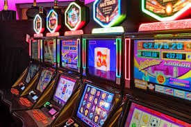 Mobile live casino-style table browsing with dark red esports design